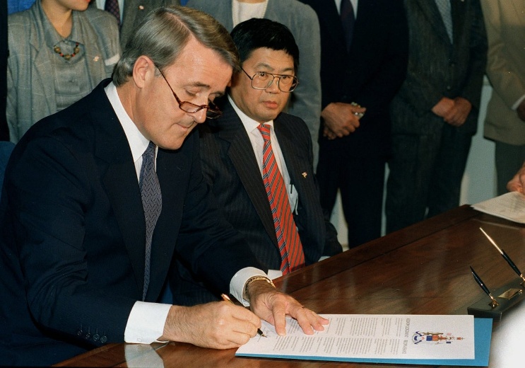 Prime Minister Brian Mulroney signing the Japanese Canadian redress document, 1988